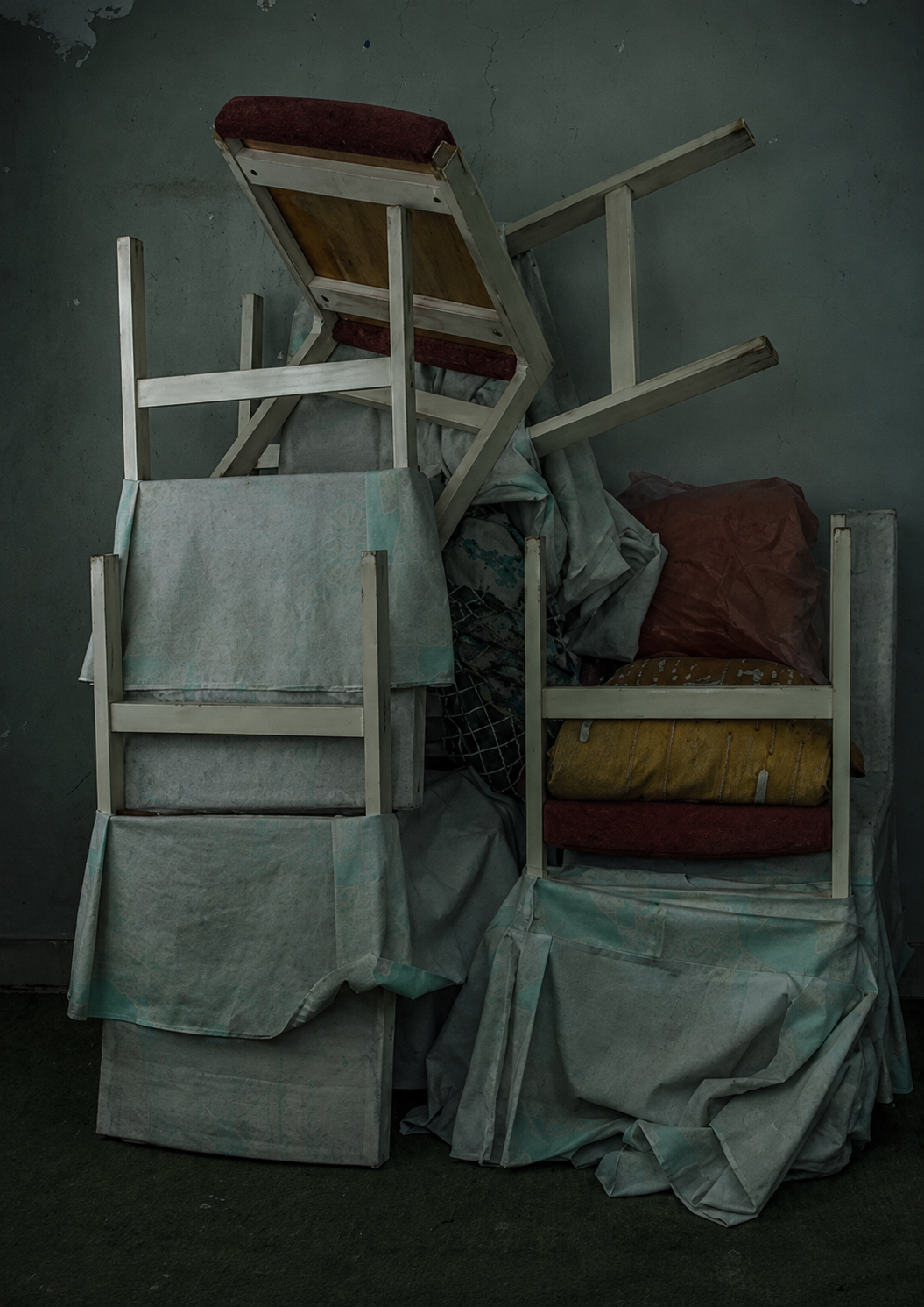 Stacked chairs and covered furniture from the EMPTY SPACE photographic series